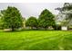 Well maintained front yard with mature trees and lush green lawn showcasing the home's curb appeal at 5356 S U.S. Highway 421, Zionsville, IN 46077