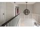 Bright upstairs hallway features a decorative light fixture and white painted railings at 5356 S U.S. Highway 421, Zionsville, IN 46077