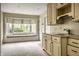 Bright kitchen with custom cabinets, countertop sink and charming window seat by the bay window at 5356 S U.S. Highway 421, Zionsville, IN 46077