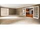 Open living room with textured walls and french doors that lead into the renovated kitchen at 5356 S U.S. Highway 421, Zionsville, IN 46077