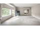 Spacious living room with neutral carpeting, large windows with custom valances, and a built-in cabinet at 5356 S U.S. Highway 421, Zionsville, IN 46077