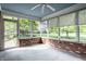 Cozy sunroom with brick accents, surrounded by large windows, offering serene views of the landscaped yard at 5356 S U.S. Highway 421, Zionsville, IN 46077