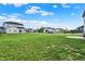 A vast, well-manicured backyard provides ample space for recreation, framed by neighboring homes at 5366 Laurel Crest Run, Noblesville, IN 46062