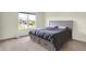 Bedroom with a gray bed frame with built-in drawers, a large window, and a view of the neighborhood at 5366 Laurel Crest Run, Noblesville, IN 46062