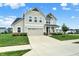 Beautiful home featuring a two-car garage, manicured lawn, and inviting front porch and walkway at 5366 Laurel Crest Run, Noblesville, IN 46062