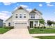 Charming two-story home features a well-manicured lawn, attached garage, and inviting front porch with white pillars at 5366 Laurel Crest Run, Noblesville, IN 46062