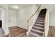 Inviting home foyer with hardwood floors, staircase, and a well-lit entryway at 5366 Laurel Crest Run, Noblesville, IN 46062