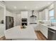 Modern kitchen with stainless steel appliances, white cabinets, quartz countertops, and central kitchen island at 5366 Laurel Crest Run, Noblesville, IN 46062