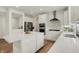 Spacious kitchen features white cabinets, stainless steel appliances, quartz countertops and a large kitchen island at 5366 Laurel Crest Run, Noblesville, IN 46062