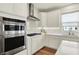 Kitchen showcases stainless steel appliances, white cabinets, quartz countertops, gas cooktop, and modern design at 5366 Laurel Crest Run, Noblesville, IN 46062