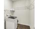 Functional laundry room equipped with a modern washer and shelving for organized storage solutions at 5366 Laurel Crest Run, Noblesville, IN 46062