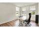 Bright office space featuring three windows, wood floors, and a desk area at 5366 Laurel Crest Run, Noblesville, IN 46062