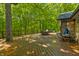 Expansive wooden deck surrounded by trees, perfect for outdoor dining and entertaining with natural views at 5920 Crooked Creek E Dr, Martinsville, IN 46151