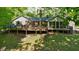 Expansive backyard view of a house with a large wooden deck and lots of natural sunlight at 5920 Crooked Creek E Dr, Martinsville, IN 46151