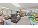 Spacious finished basement with recreational areas, including a pool table, play area, and gym equipment at 5920 Crooked Creek E Dr, Martinsville, IN 46151