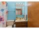 Small bathroom features a vanity with mirror and a toilet with blue walls and decorative shower curtain at 5920 Crooked Creek E Dr, Martinsville, IN 46151