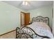Cozy bedroom with vintage metal bed frame and side table with reading lamp at 5920 Crooked Creek E Dr, Martinsville, IN 46151