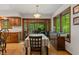 Inviting dining room featuring wood floors, cabinetry, and views of the outdoors through sliding glass doors at 5920 Crooked Creek E Dr, Martinsville, IN 46151