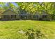 Attractive brick home featuring a well-manicured front yard, mature trees, and classic design at 5920 Crooked Creek E Dr, Martinsville, IN 46151