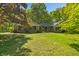 Charming brick home featuring a well-manicured lawn, mature trees, and classic architectural details at 5920 Crooked Creek E Dr, Martinsville, IN 46151