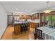 Charming kitchen featuring wood cabinets, a breakfast bar, and a bright atmosphere with an adjacent dining area at 5920 Crooked Creek E Dr, Martinsville, IN 46151
