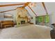 Cozy living room with a stone fireplace, wood beams, and a sliding door to the outside at 5920 Crooked Creek E Dr, Martinsville, IN 46151