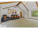Bright living room featuring vaulted ceilings with wood beams, and a view of the front door and window at 5920 Crooked Creek E Dr, Martinsville, IN 46151