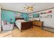 Serene main bedroom with wood floors, a ceiling fan, and a calming blue accent wall at 5920 Crooked Creek E Dr, Martinsville, IN 46151