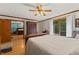 Comfortable main bedroom with wood floors, closet doors, and a sliding glass door leading to the outdoors at 5920 Crooked Creek E Dr, Martinsville, IN 46151