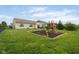 Expansive backyard features a playset, lush green lawn, and a patio seating area perfect for outdoor gatherings at 5957 Haywood Ct, Greenwood, IN 46142