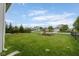 Expansive backyard features a playset, lush green lawn, and houses in a neighborhood at 5957 Haywood Ct, Greenwood, IN 46142