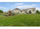 Expansive backyard features a playset, lush green lawn, and a patio seating area perfect for outdoor gatherings at 5957 Haywood Ct, Greenwood, IN 46142