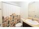 Cozy bathroom with floral shower curtain, white toilet, and vanity sink at 5957 Haywood Ct, Greenwood, IN 46142
