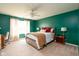 Comfortable bedroom featuring a ceiling fan, plush carpeting, and abundant natural light at 5957 Haywood Ct, Greenwood, IN 46142