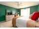 Stylish bedroom with green walls, a large window, and modern furniture at 5957 Haywood Ct, Greenwood, IN 46142