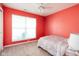 Bedroom with plush carpet, neutral walls, a ceiling fan, and a large window offering natural light at 5957 Haywood Ct, Greenwood, IN 46142