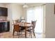 Cozy dining area with a wooden table, seating for four, and natural light from a sliding glass door at 5957 Haywood Ct, Greenwood, IN 46142