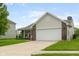 Traditional home with two-car garage, neat lawn, and well-maintained landscaping at 5957 Haywood Ct, Greenwood, IN 46142