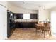 Eat-in kitchen with dark wood cabinets, stainless appliances, and tile flooring adjoins dining area at 5957 Haywood Ct, Greenwood, IN 46142
