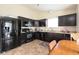 Well-equipped kitchen with dark cabinets, modern appliances, and ample counter space at 5957 Haywood Ct, Greenwood, IN 46142