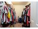 Spacious walk-in closet providing ample storage with hanging racks and shelving for clothing and accessories at 5957 Haywood Ct, Greenwood, IN 46142