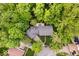 Stunning aerial view of a house with a gray roof, surrounded by lush greenery, and a deck area in the backyard at 5958 Cape Cod Ct, Indianapolis, IN 46250