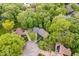 Aerial view of a serene home surrounded by mature trees, highlighting its private and lush setting at 5958 Cape Cod Ct, Indianapolis, IN 46250