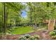 Expansive backyard with wooden deck, lush lawn, and mature trees for ultimate outdoor enjoyment at 5958 Cape Cod Ct, Indianapolis, IN 46250