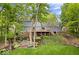 Spacious backyard featuring a two-story home with a large deck and landscaped garden at 5958 Cape Cod Ct, Indianapolis, IN 46250