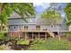 Well-maintained backyard with a two-story home, a spacious deck, and mature landscaping at 5958 Cape Cod Ct, Indianapolis, IN 46250