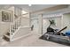 Spacious basement area with workout equipment, staircase and neutral carpet, offering potential for fitness and recreation at 5958 Cape Cod Ct, Indianapolis, IN 46250