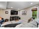 Finished basement with large TV, comfortable seating and a door leading to the outside at 5958 Cape Cod Ct, Indianapolis, IN 46250