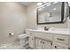 Neutral half bathroom featuring a white vanity with drawers and a toilet at 5958 Cape Cod Ct, Indianapolis, IN 46250