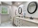 Tasteful bathroom with double sink vanity, granite countertops, and decorative mirrors at 5958 Cape Cod Ct, Indianapolis, IN 46250